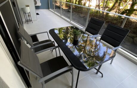 Renovated balcony in Hope Island styled with elegant outdoor furniture.